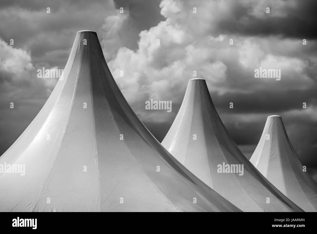 Black and white detail of big top tent against a dramatic sky. Stock Photo