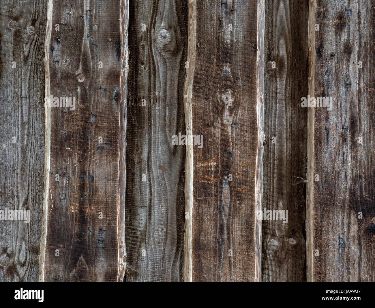 Planks of a wooden wall as a background. Old wood of a barn, Planken einer Holzwand als Hintergrund. Altholz einer Scheune Stock Photo