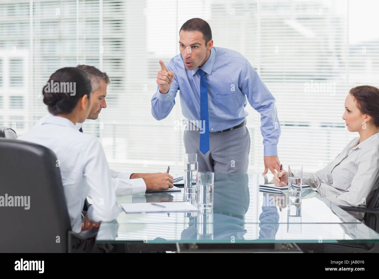 Angry executive pointing out employee hi-res stock photography and ...