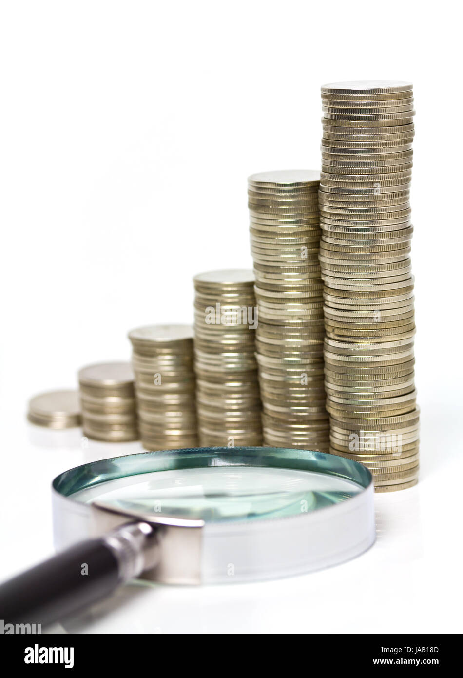 coins stacks with magnifying glass Stock Photo Alamy
