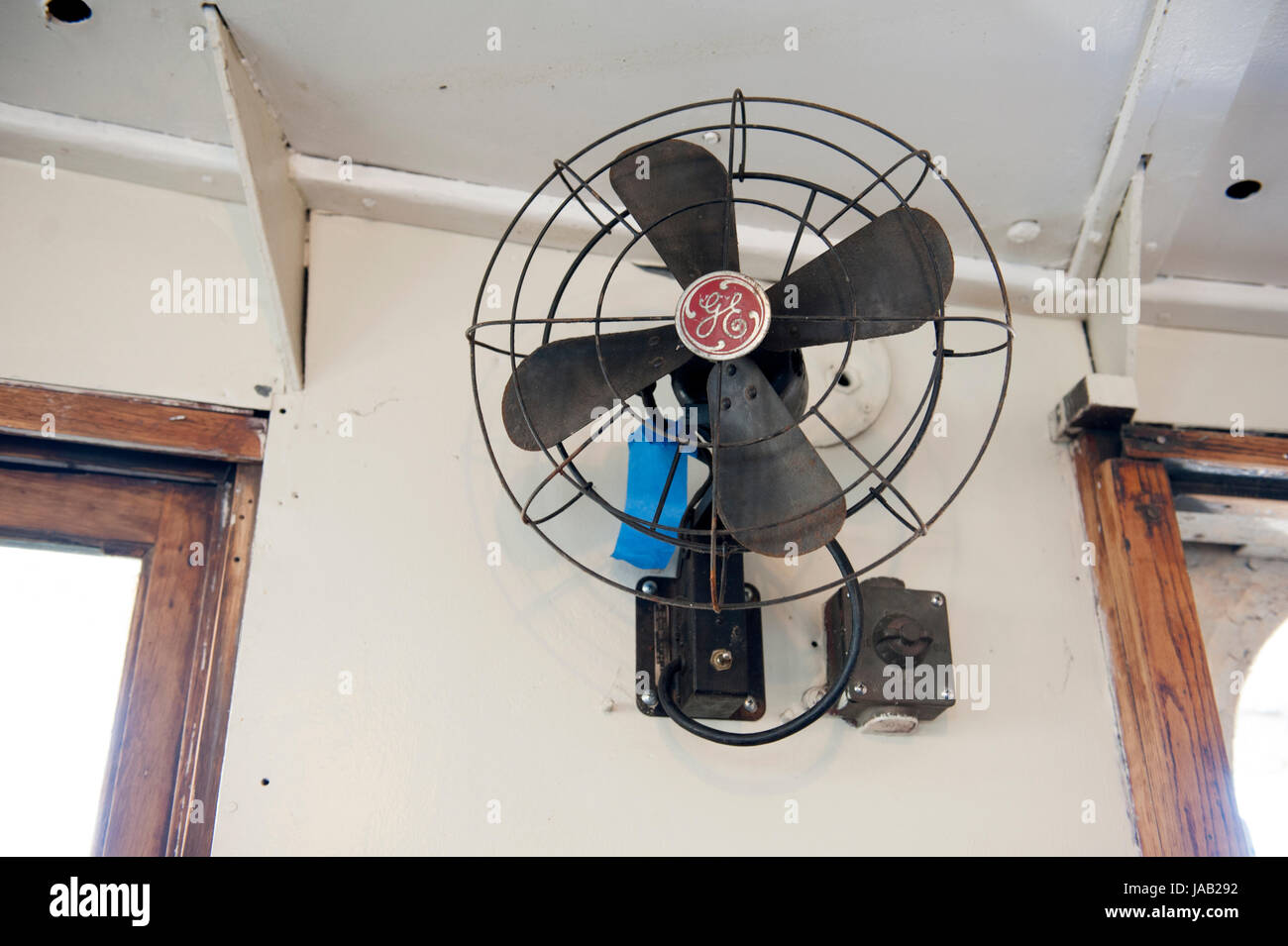 An old General Electric fan is on the lighthouse tender, Lilac. The ship, berthed in Manhattan, is on the National Register of Historic Places. Stock Photo