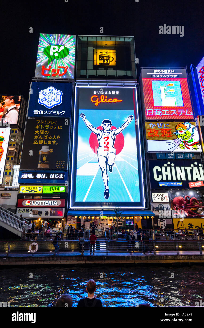 Dotonbori, the principal tourist destinations in Osaka. Ebisu bridge area, famous Glico sign of running man illuminated at night on the waterfront. Stock Photo