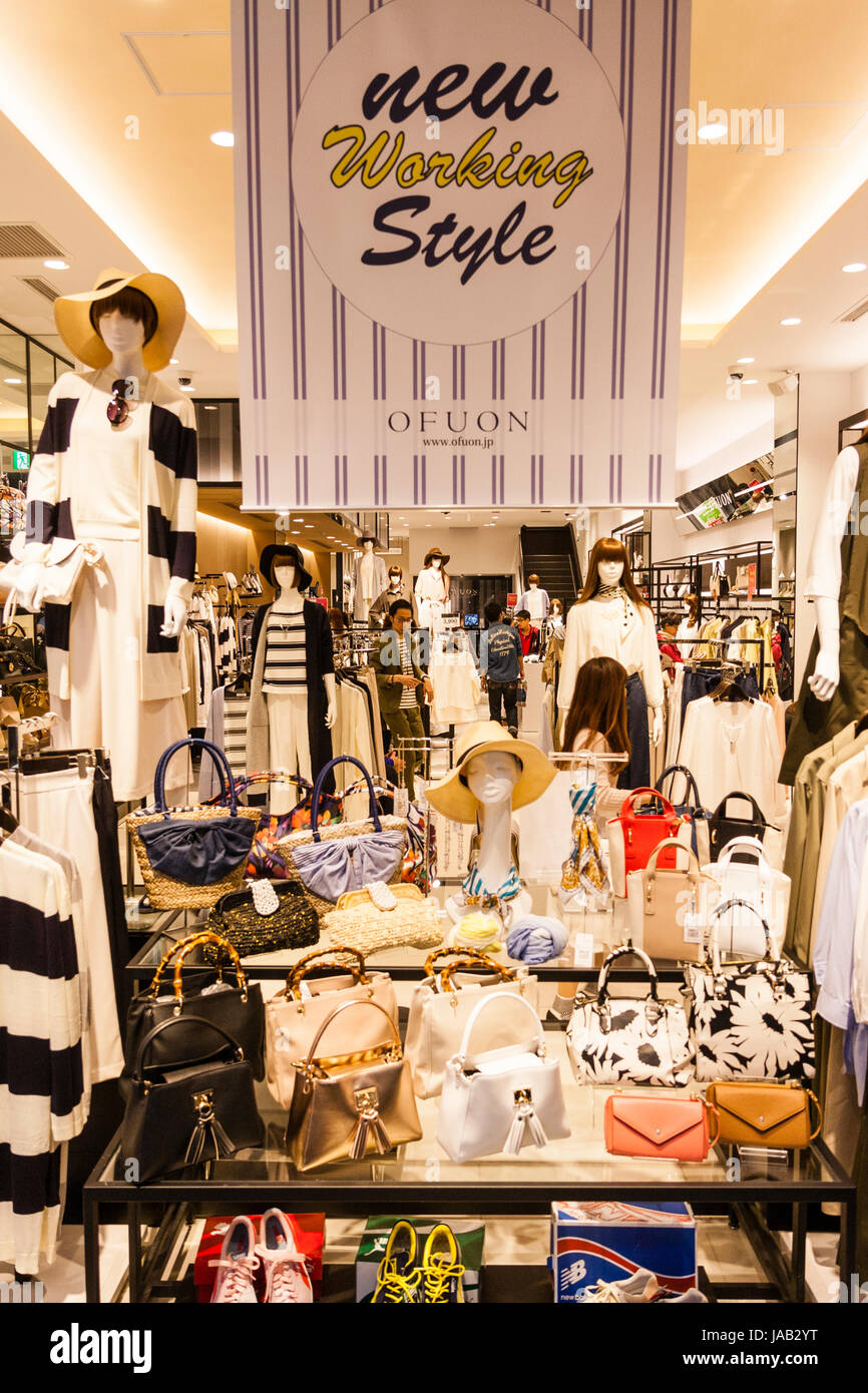 Japan, Osaka, Shinsaibashi. Interior of Ofuon women's fashion store. Main display stand with women's handbags and purses, above that a sign. Stock Photo