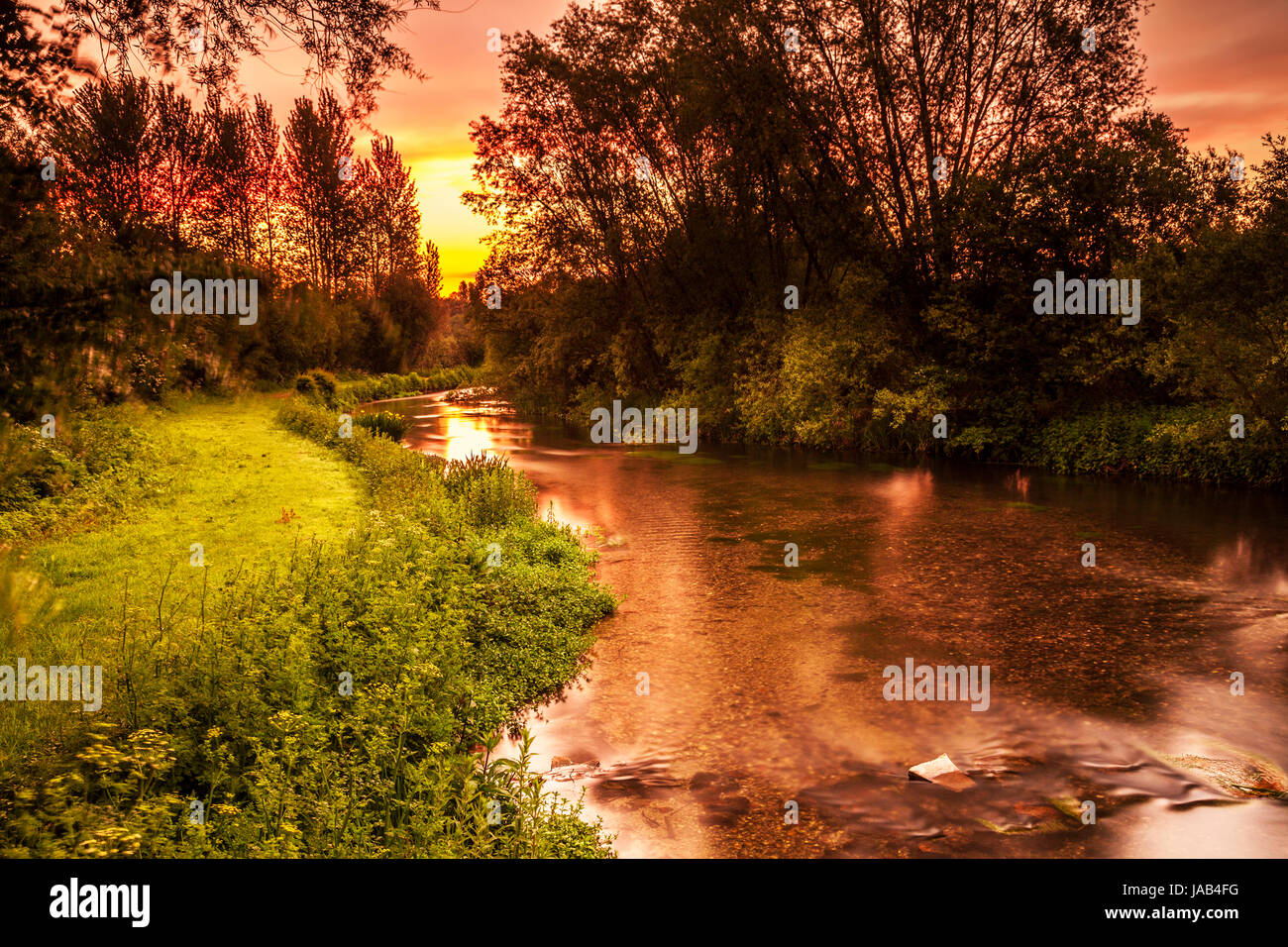 A colourful and dramatic sunrise over the River Kennet in Wiltshire. Stock Photo