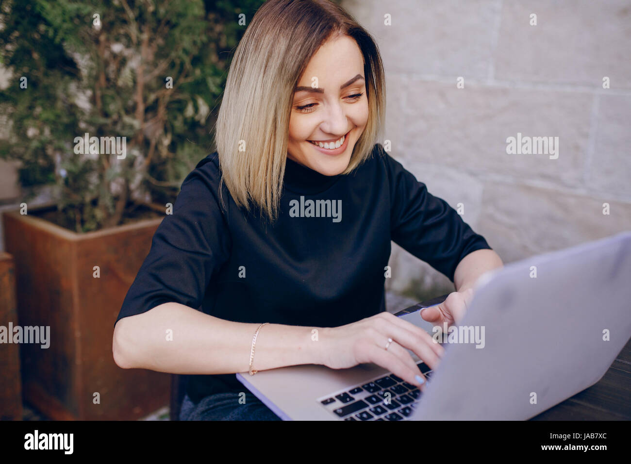 young beautiful girl using the laptop sitting smiling Stock Photo - Alamy