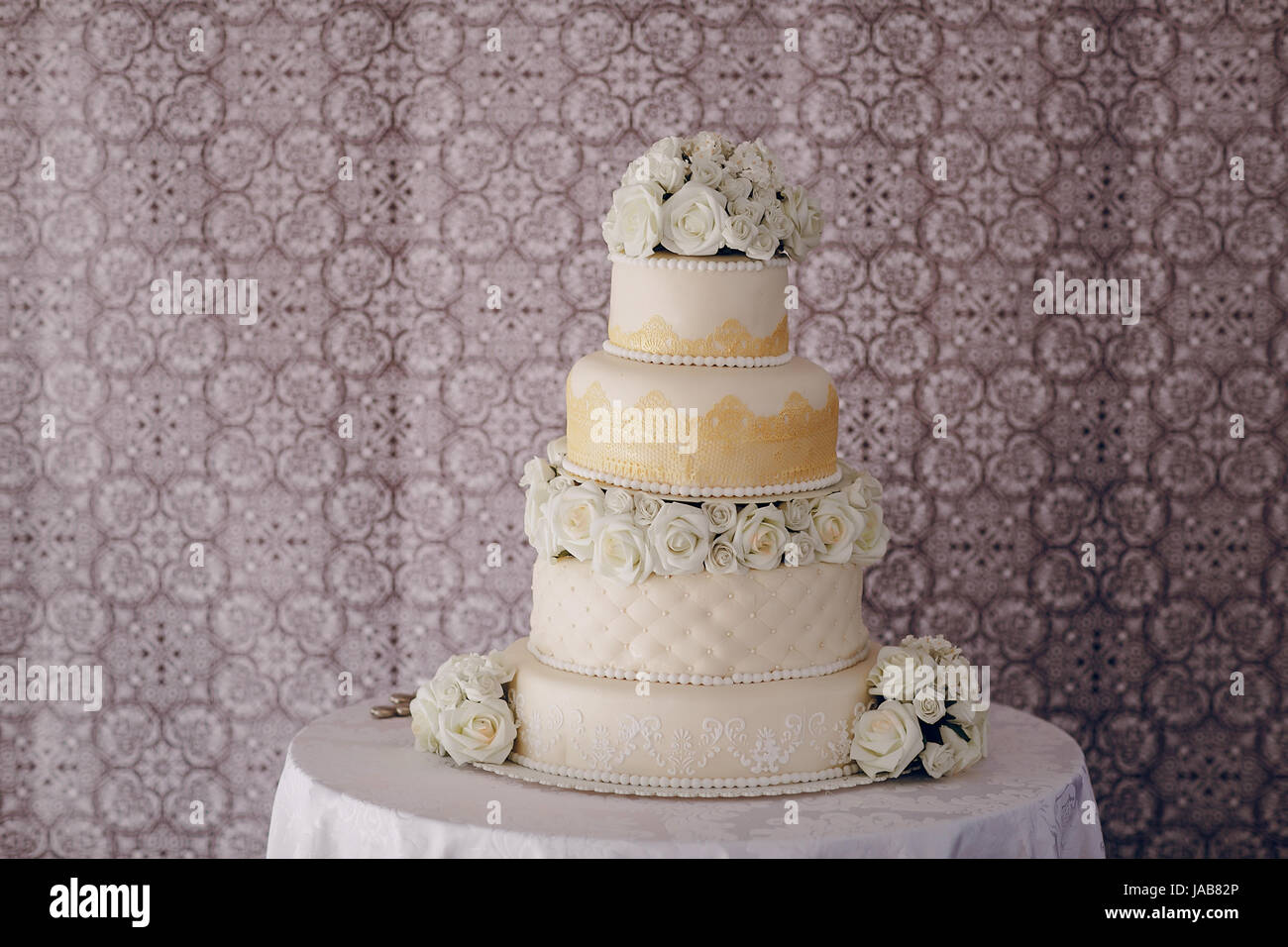 On The Table Is A Large White Wedding Cake Stock Photo 144077326