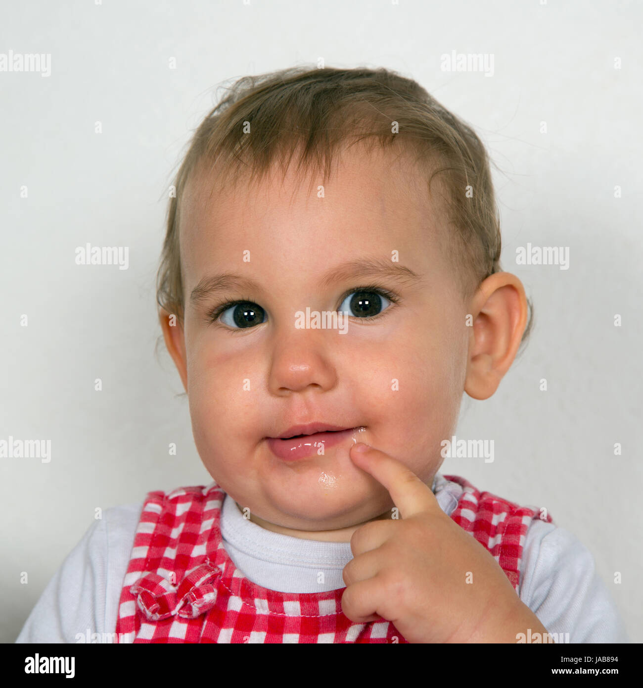 Portrait von einem Baby, das neugierig ist und in die Kamera schaut Stock Photo