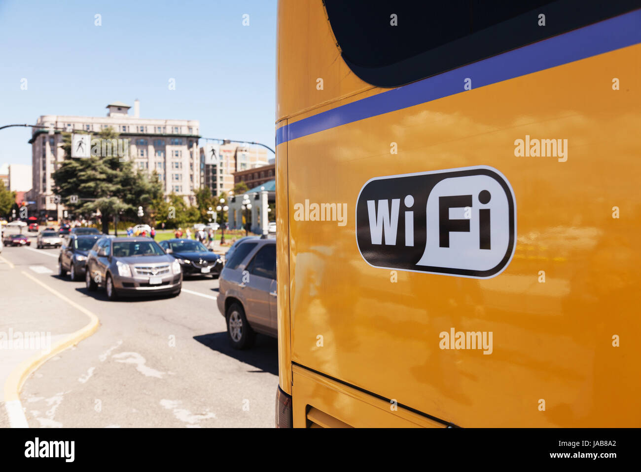 Yellow bus with wifi decal on side.  Victoria BC Stock Photo