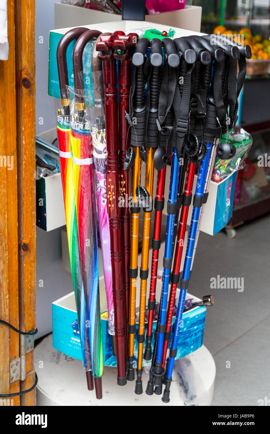 Guangxi, China.  Between Yangshuo and Longji.  Umbrellas and Walking Sticks for sale. Stock Photo