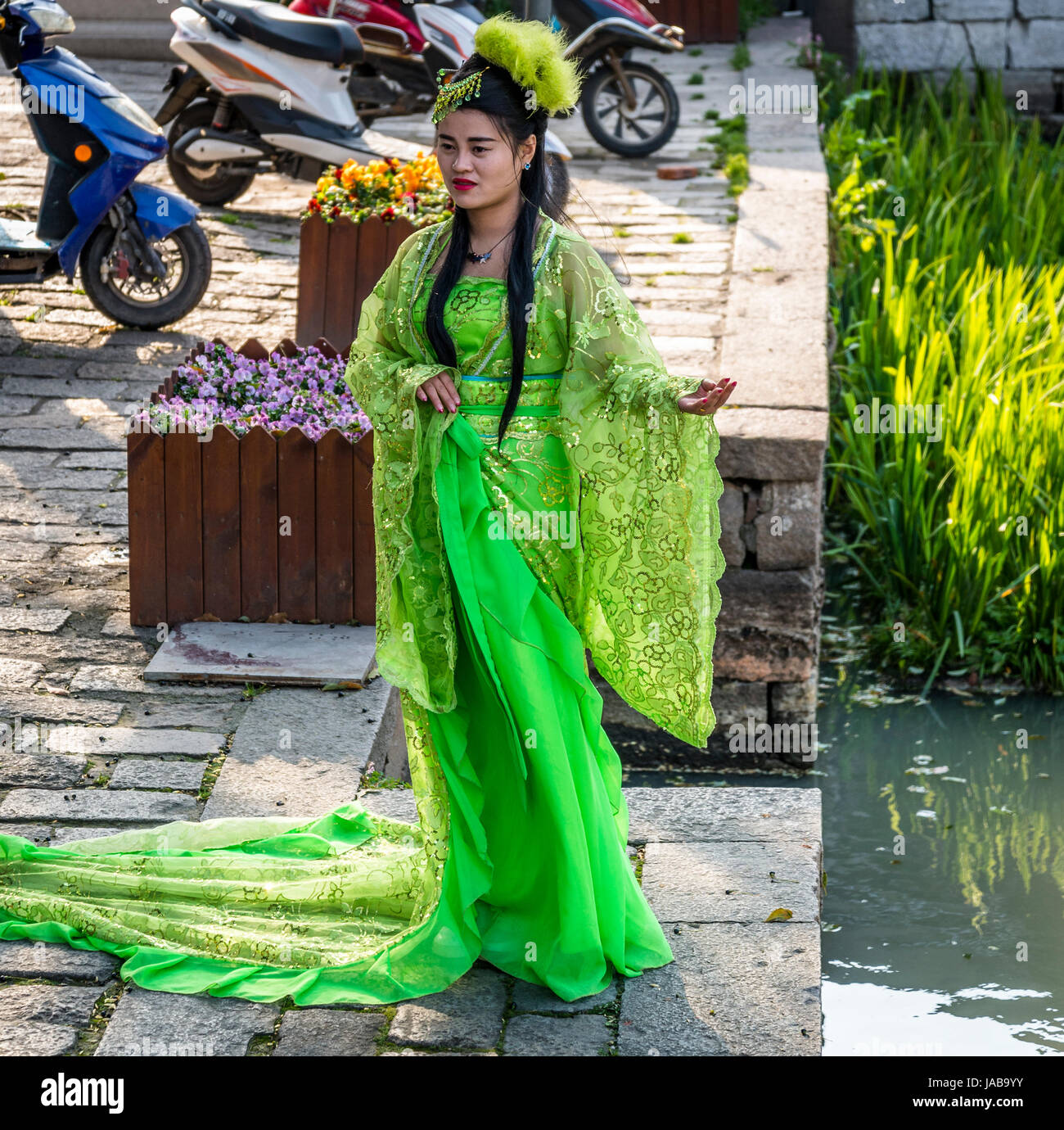Woman dressed in traditional clothes posing for a photographer, Ancient  water town of Tongli, Suzhou, Jiangsu Province, China Stock Photo - Alamy