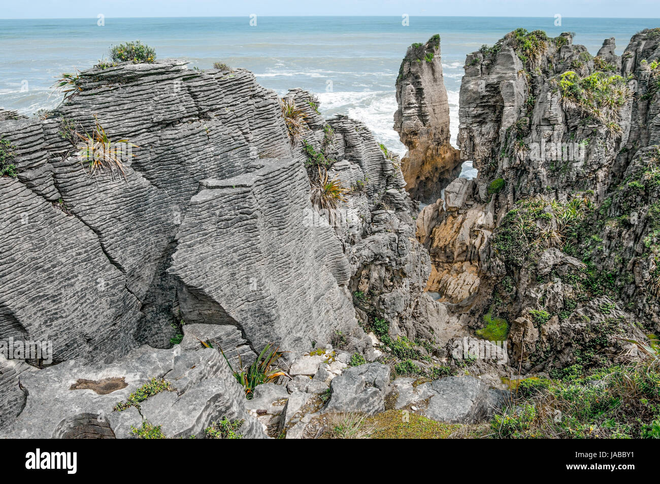 New Zealand Coastal Rocks:  Patterns of sedimentation and erosion show in finely detailed “pancake” rock formations on the west coast of New Zealand. Stock Photo