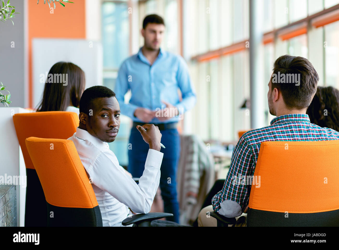 business, startup, presentation, strategy and people concept - man making presentation to creative team at office Stock Photo