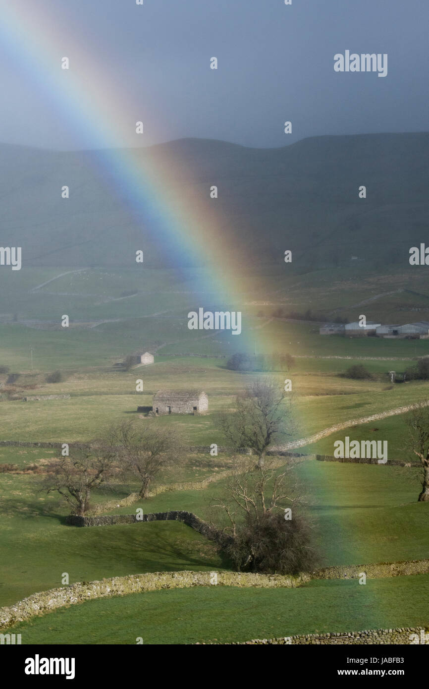 Rainbow over the countryside in upper Wensleydale near Hawes, North Yorkshire, UK. Stock Photo