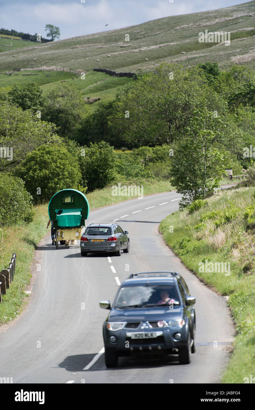 Vehicles overtaking on a busy rural road in Cumbria, UK. Stock Photo