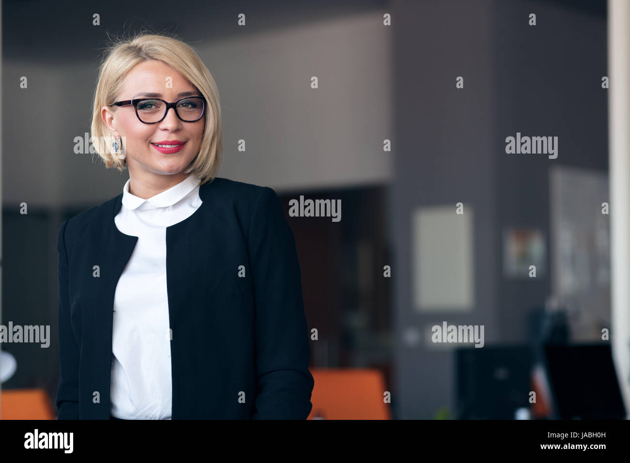 Happy young business woman with a folder at office building Stock Photo ...
