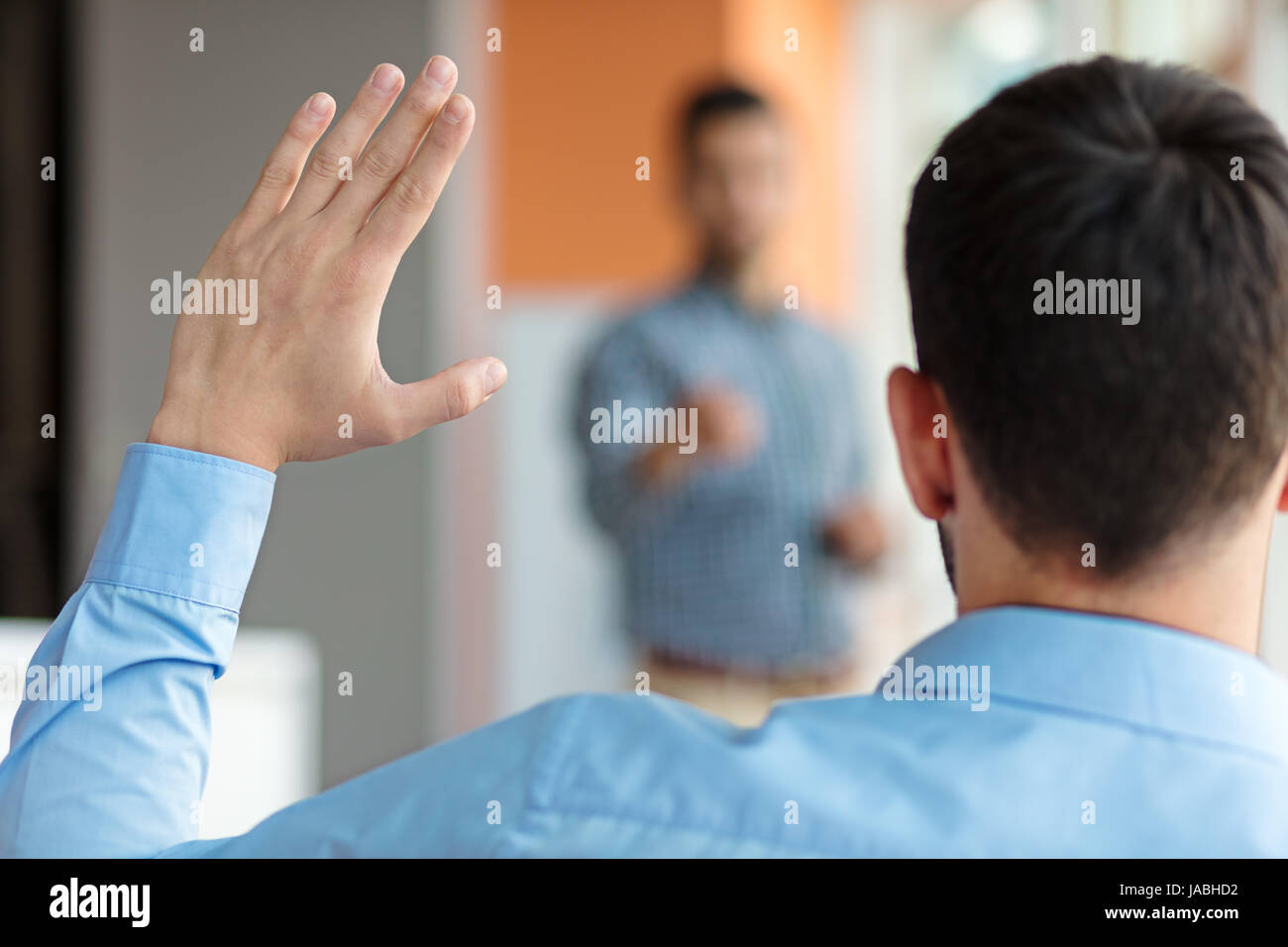 Business people Raising there Hand Up at a Conference to answer a question Stock Photo