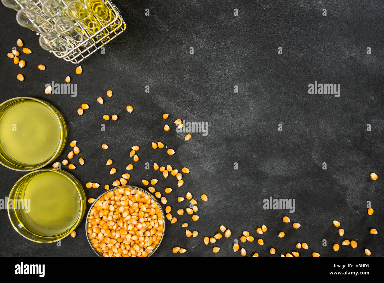 research on gold corn energy food through the particles in the laboratory testing with test tubes on the black board writing the report using chalk on Stock Photo
