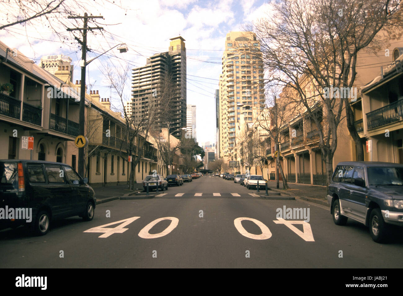 Sydney street scene featuring terraced houses in the inner-city suburb of Surry Hills and showing 40 km speed restriction signs painted on the road. Stock Photo