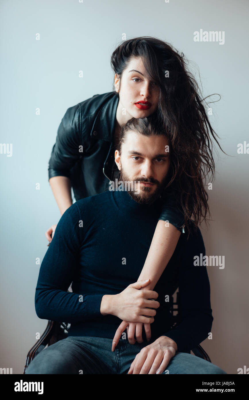 Guy sitting on a chair, girl standing behind him Stock Photo Alamy