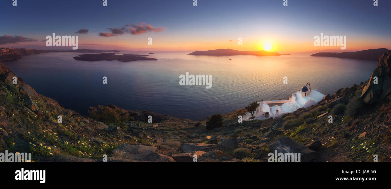 Amazing sunset at Panagia Theoskepasti, on the Skaros rock at Imerovigli, Santorini, Crete, Greece. Stock Photo