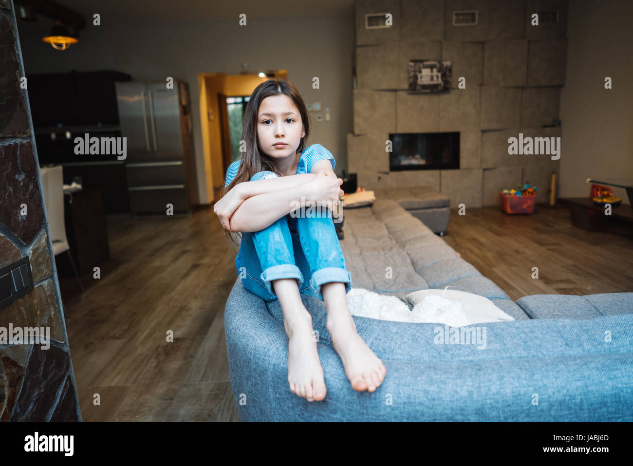 Positive smiling teenage girl on a couch Stock Photo - Alamy