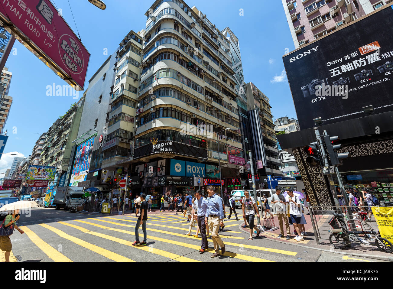 Hong Kong - June 16 2015: Mong kok is characterized by a mixture of old and new multi-story buildings, with shops and restaurants at street level. Stock Photo