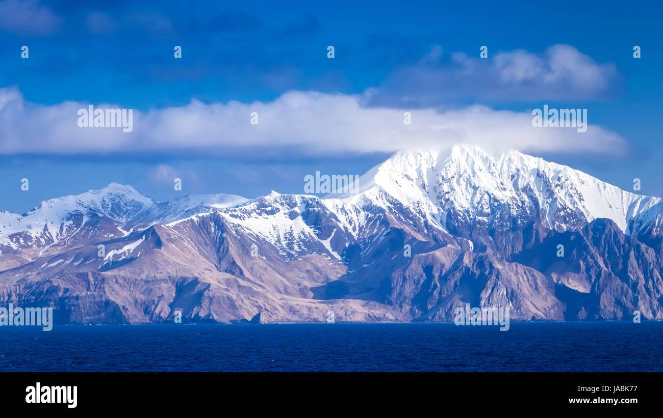 A chain of snow capped mountains in the Aleutian Islands near Unimak Passage, Alaska, USA. Stock Photo