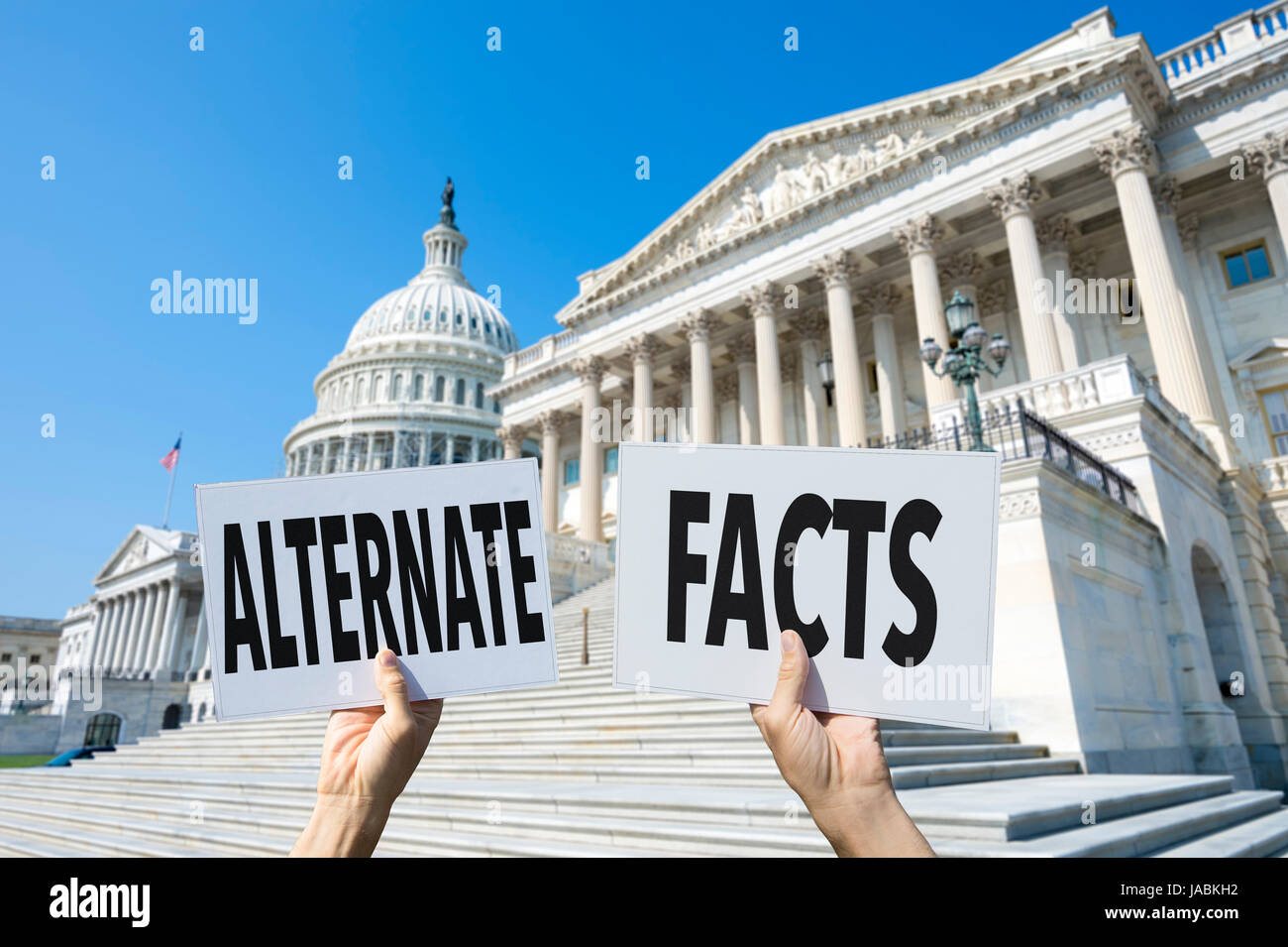 Hands holding signs protesting fake news coverage in front of the Capitol Building in Washington DC, USA Stock Photo