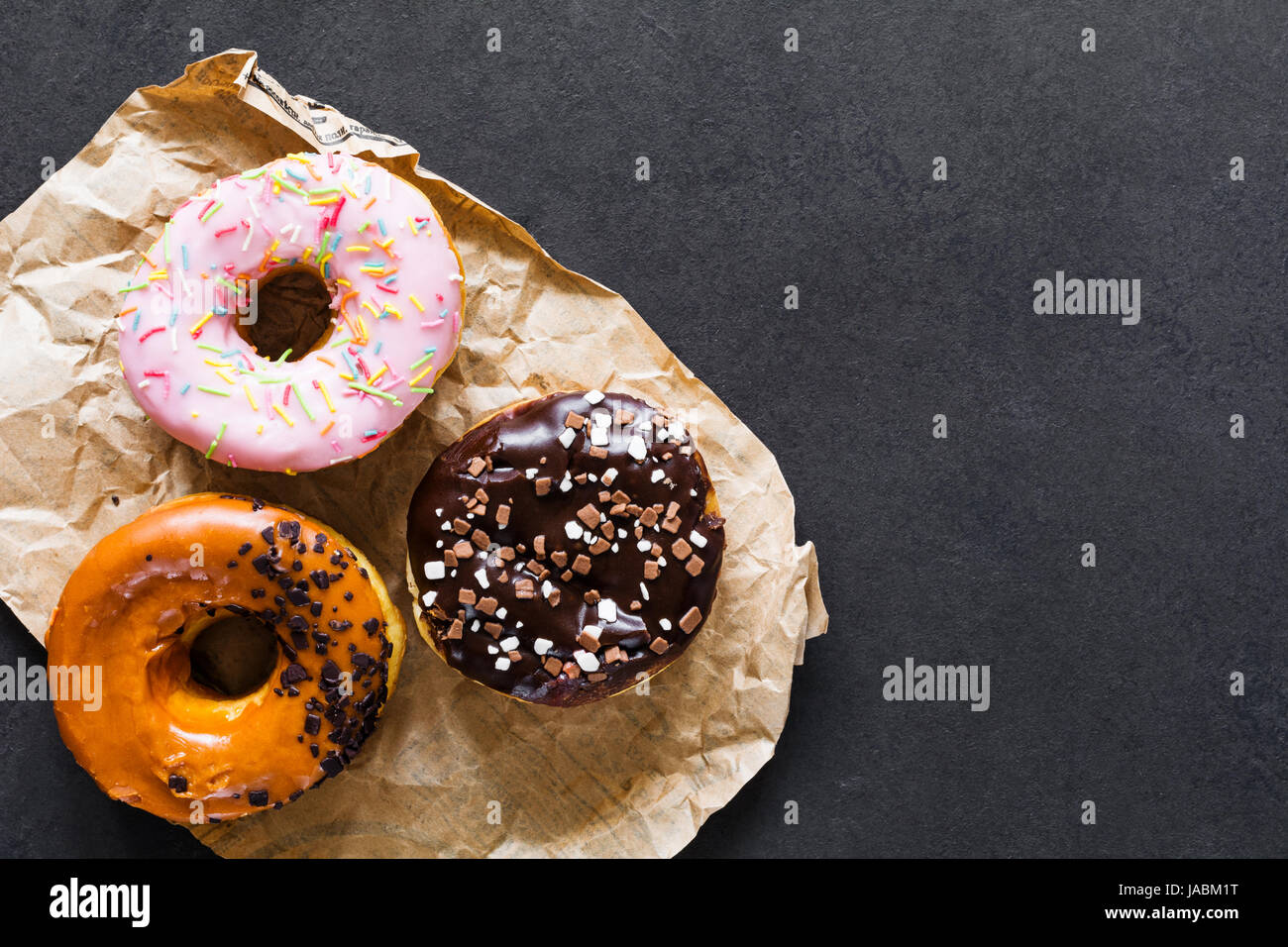 Glazed donuts on dark background. Table top view and copy space Stock ...