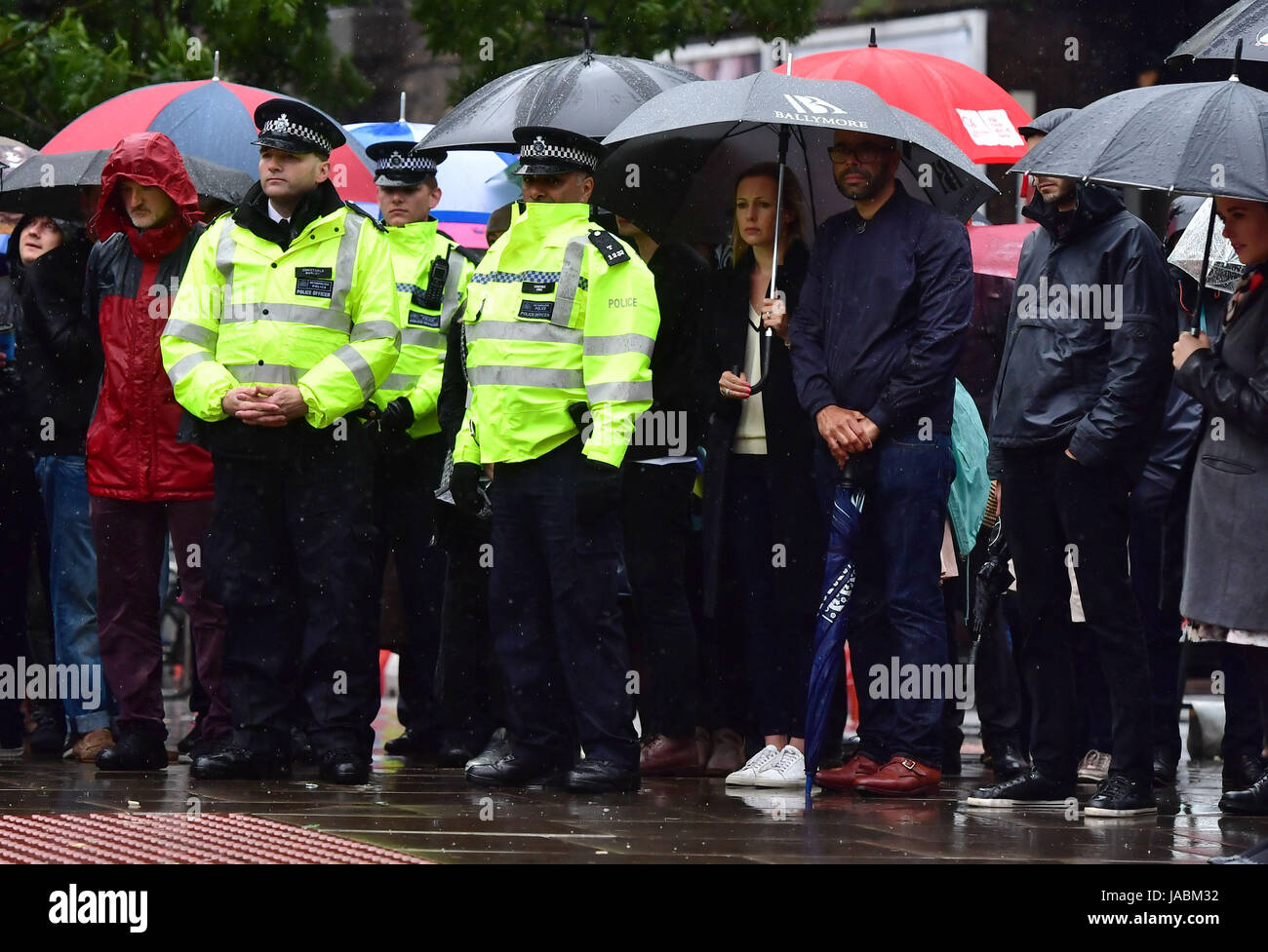 People and police officers observe a minute's silence on London Bridge