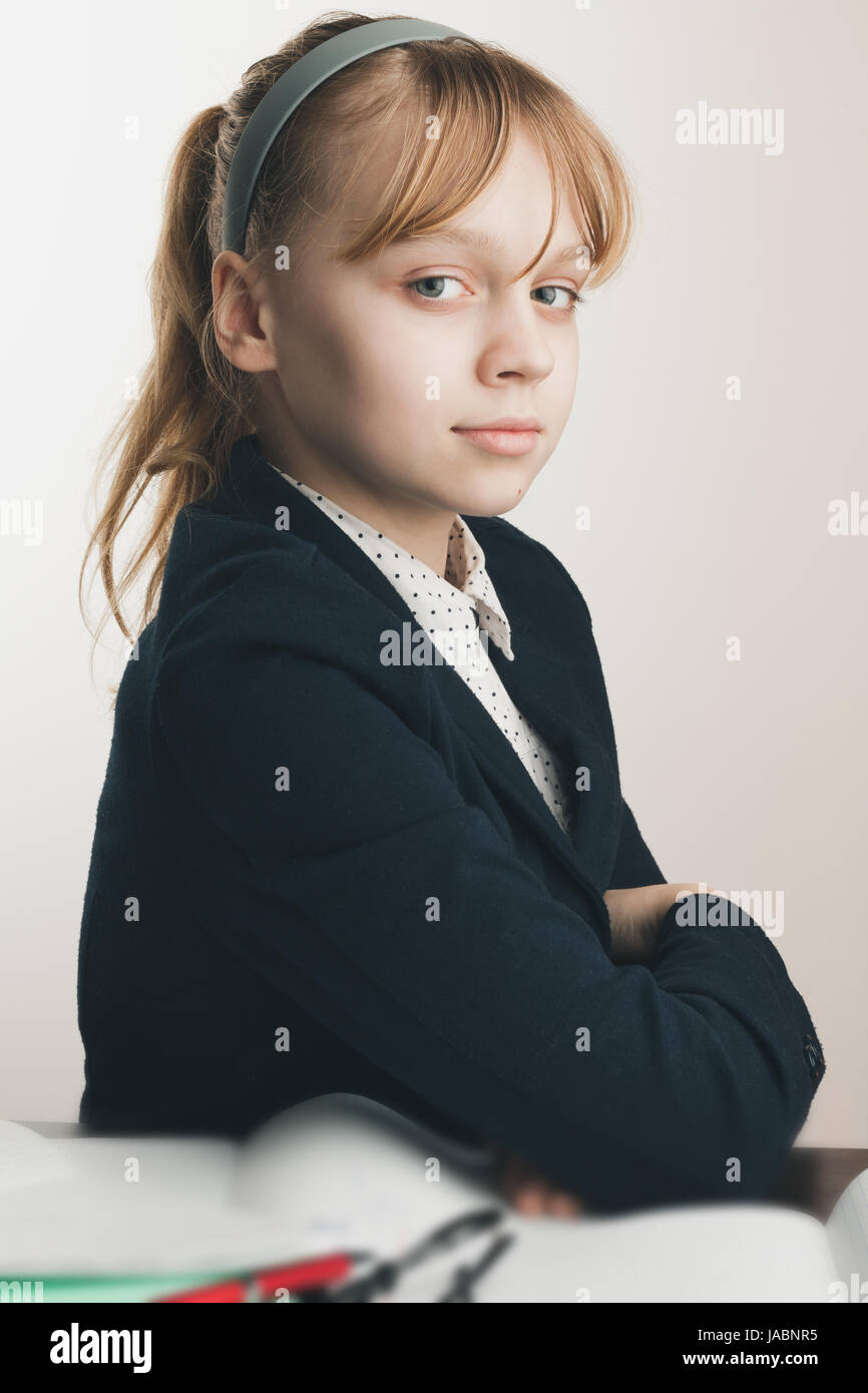 European school girl, closeup portrait over white wall background Stock Photo