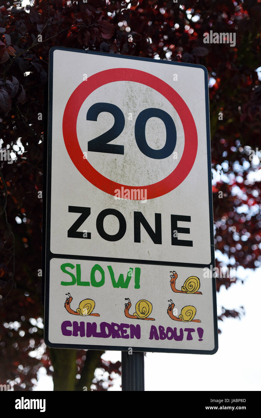 20mph speed limit zone sign with snails, slow, children about. Urban traffic calming Stock Photo