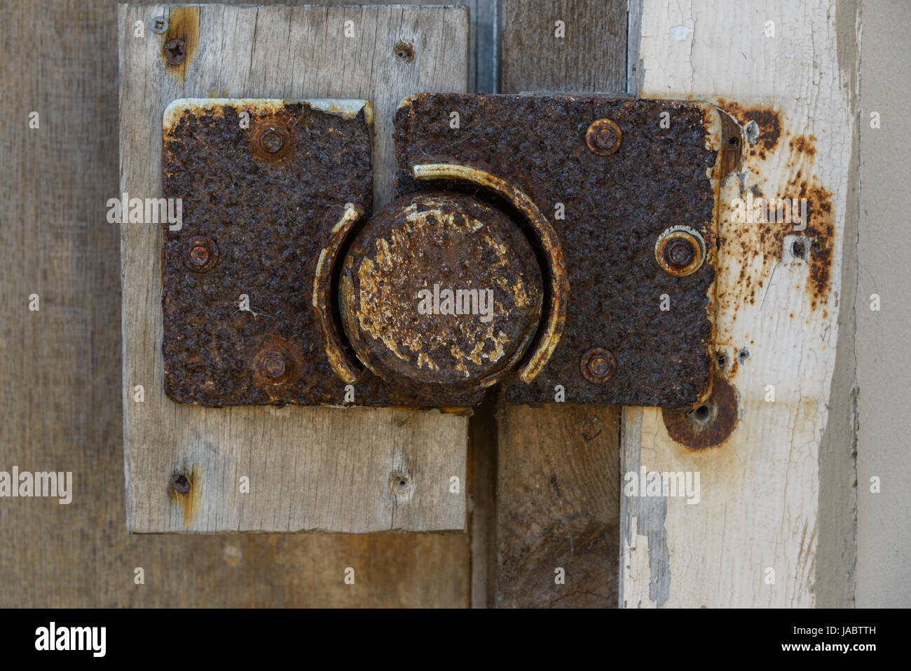 Heavily corroded lock on outside door. Tenby. Pembrokeshire. UK. Stock Photo