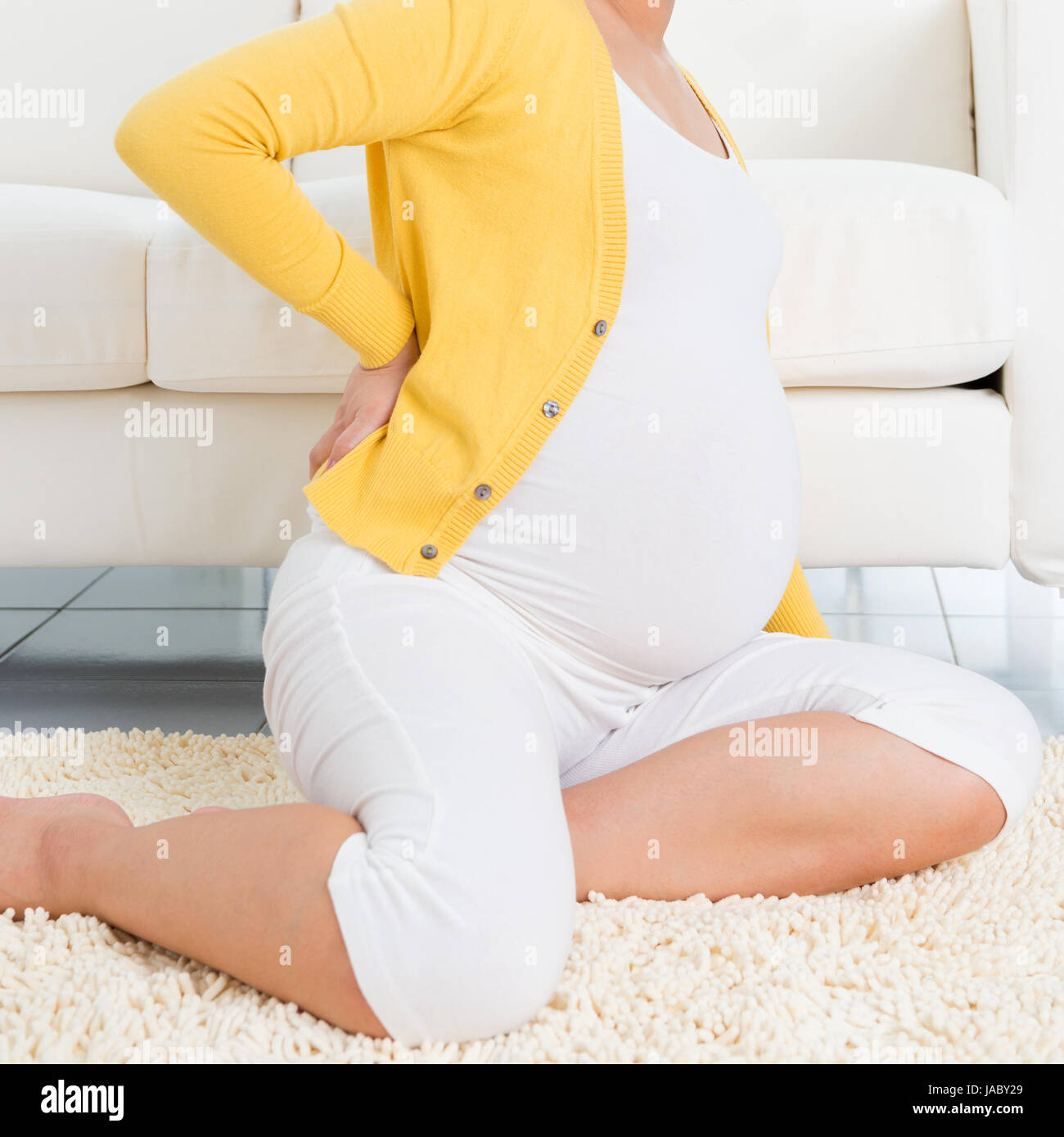 Back Pain 8 Months Pregnant Woman Holding Her Back While Sitting