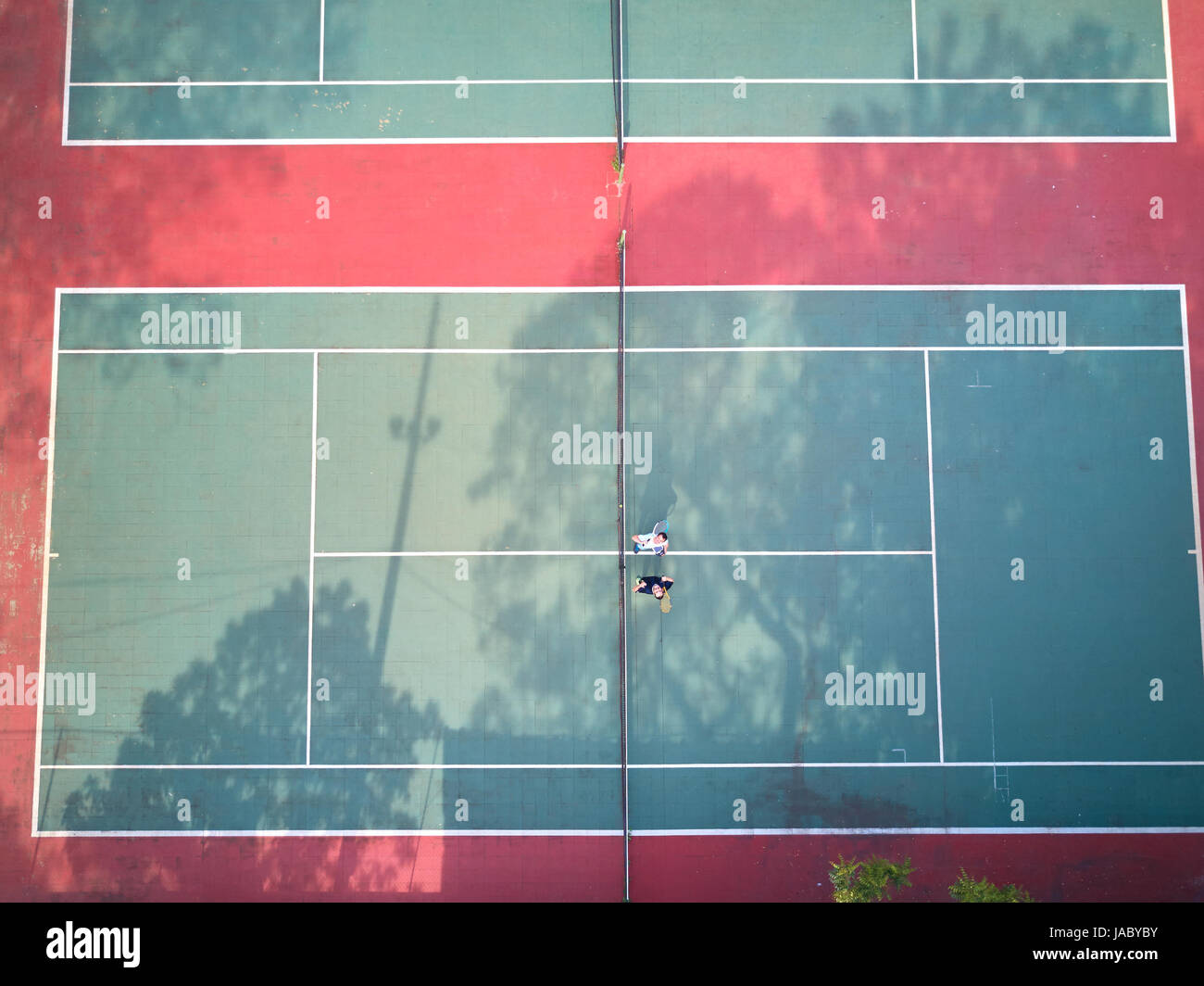 Two mans in tennis court aerial above view from drone Stock Photo