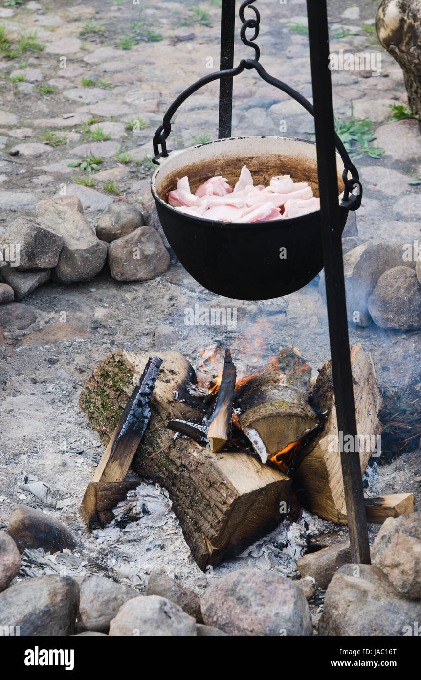 camping cooking on campfire with old iron pots Stock Photo - Alamy