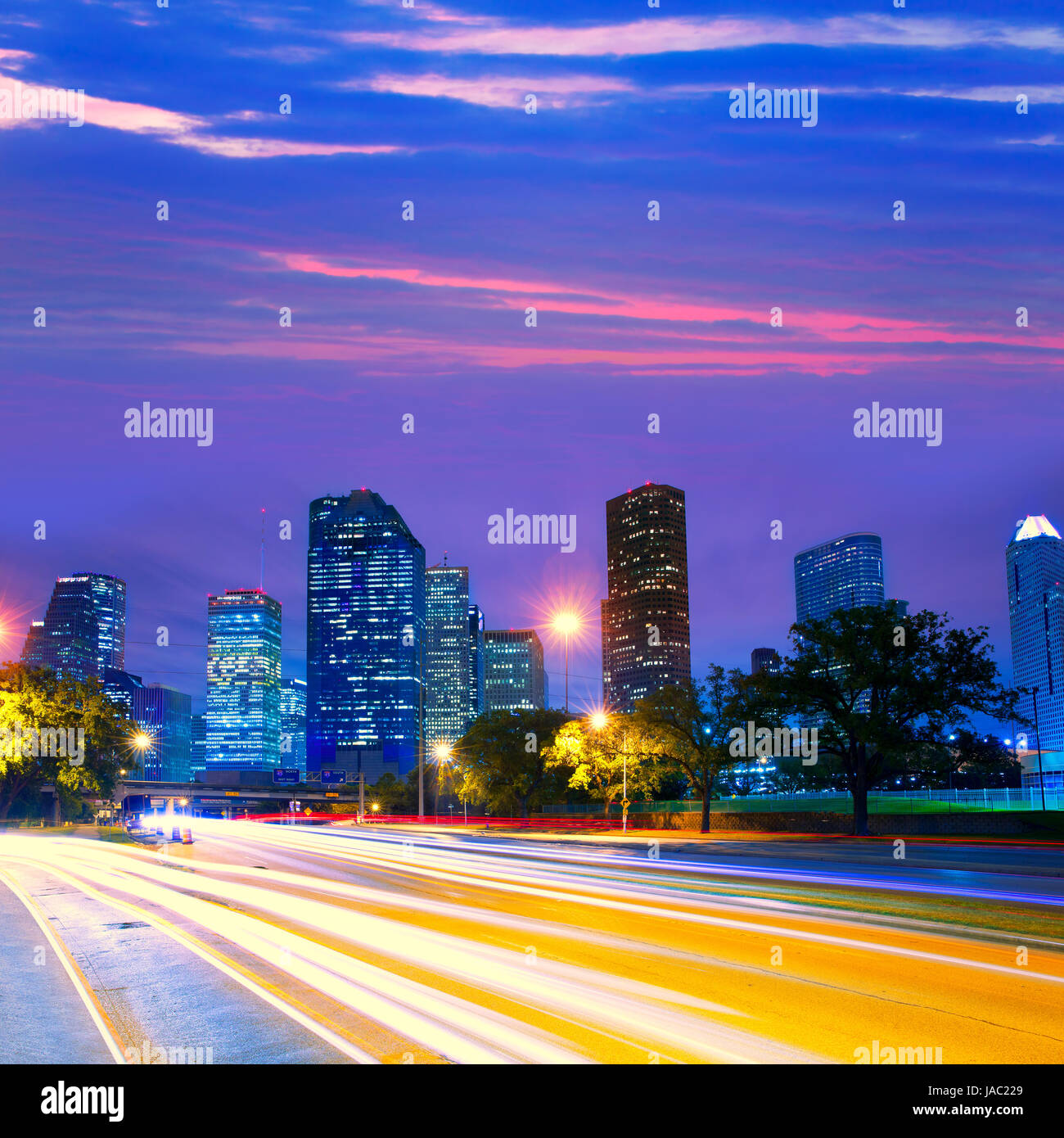 Houston Texas modern skyline at sunset twilight with traffic headlights