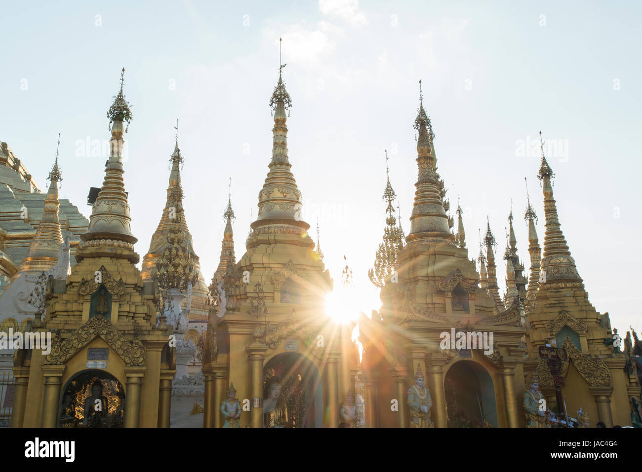The sun sets behind Pagodas at the Shwedagon Pagoda in Yangon (Rangoon), Myanmar (Burma) Stock Photo