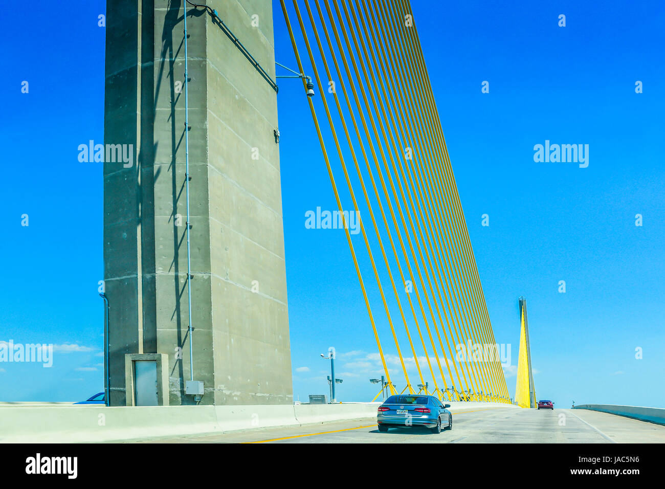 The Sunshine Skyway Bridge built over Tampa Bay is a cable stayed bridge with visually exciting yellow cables construction near St. Petersburg, FL Stock Photo