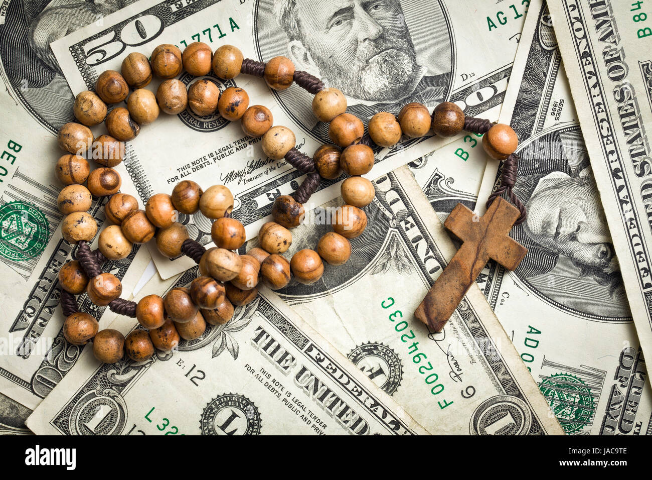 top view of rosary beads on us dollars background Stock Photo