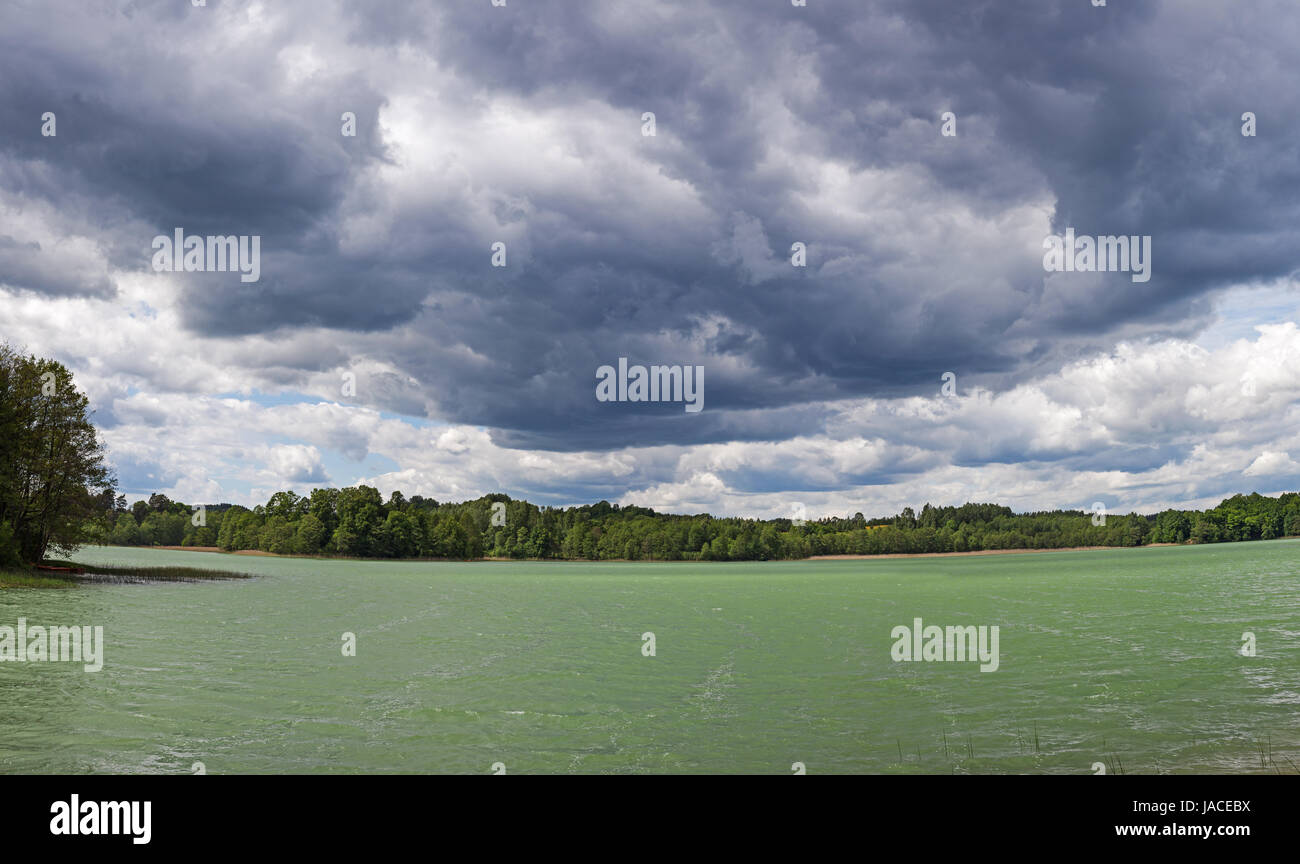 Stormy sky over emerald lake, HDR image, Poland, Europe Stock Photo