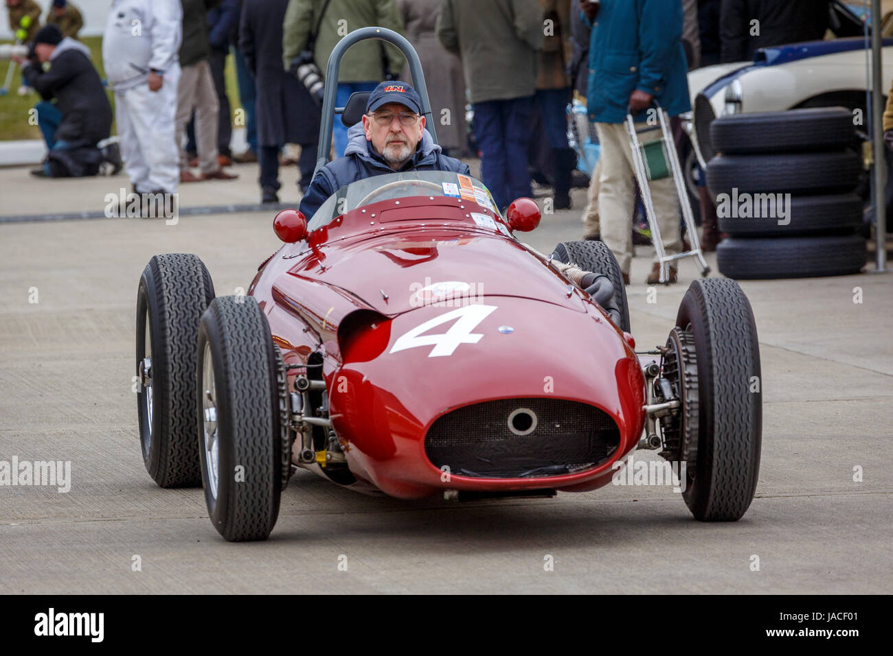 1957 Maserati 250F drives through the paddock before the Brooks Trophy race at the Goodwood GRRC 74th Members Meeting, Sussex, UK. Stock Photo
