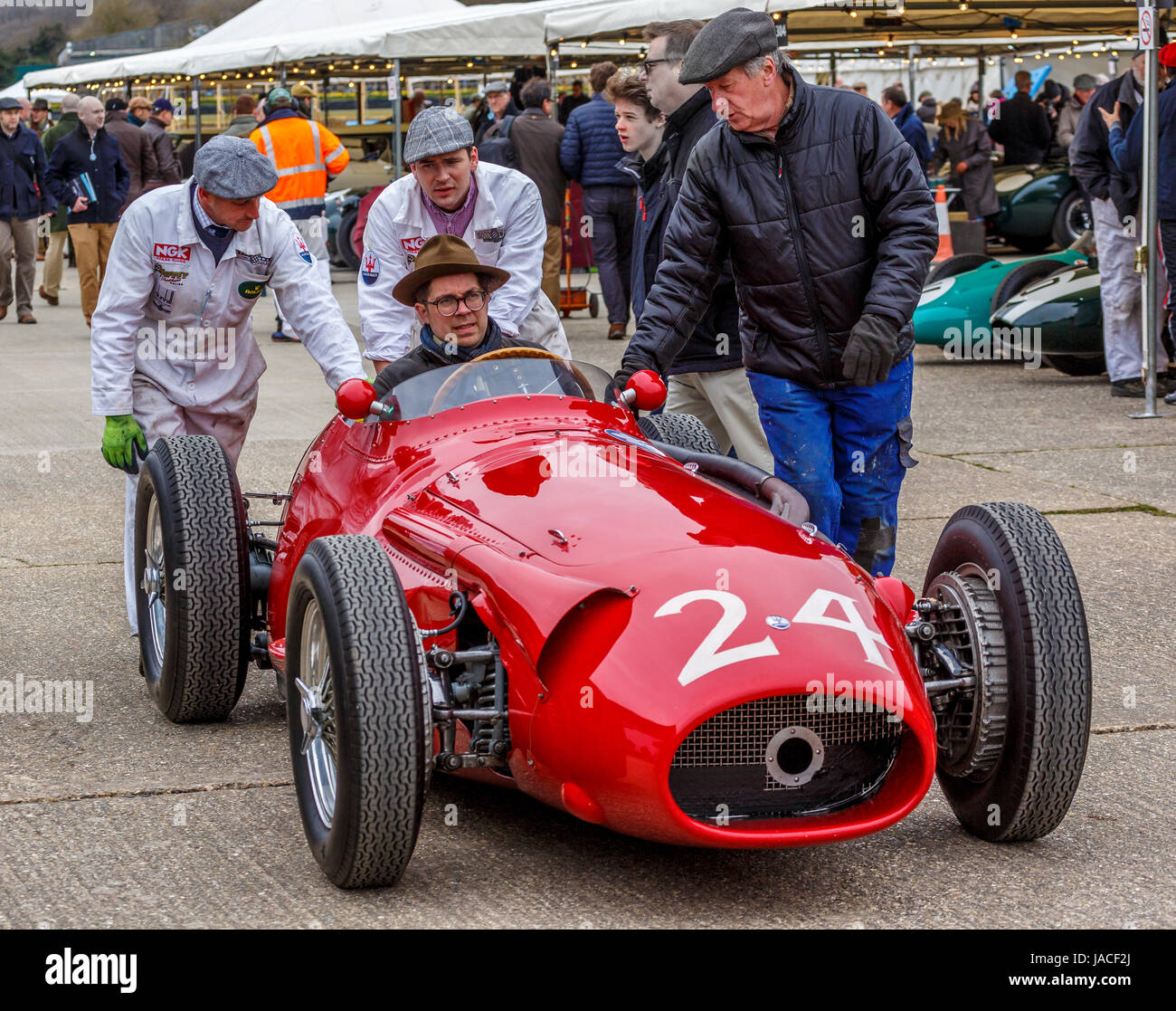 1955 Maserati 250F is pushed through the paddock before the Brooks Trophy race at the Goodwood GRRC 74th Members Meeting, Sussex, UK. Stock Photo