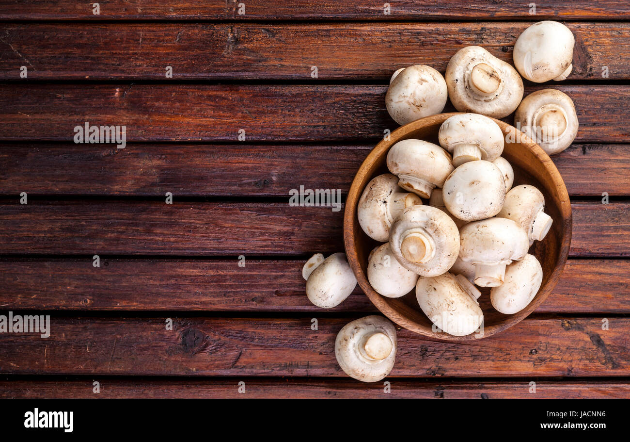 Top view of mushrooms champignon on wooden table. Copy space. Stock Photo