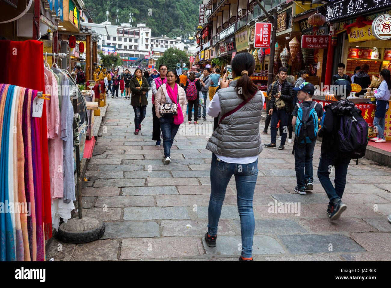 Yangshuo, China.  Street Scene.  Woman Taking Picture with Cell Phone. Stock Photo