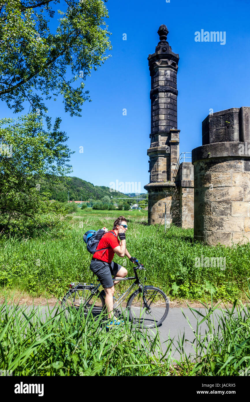 Biker on a bike trail in the valley along the Elbe Valley, Saxon Switzerland region, bridge Bad Schandau, Saxony, Germany, Europe Stock Photo