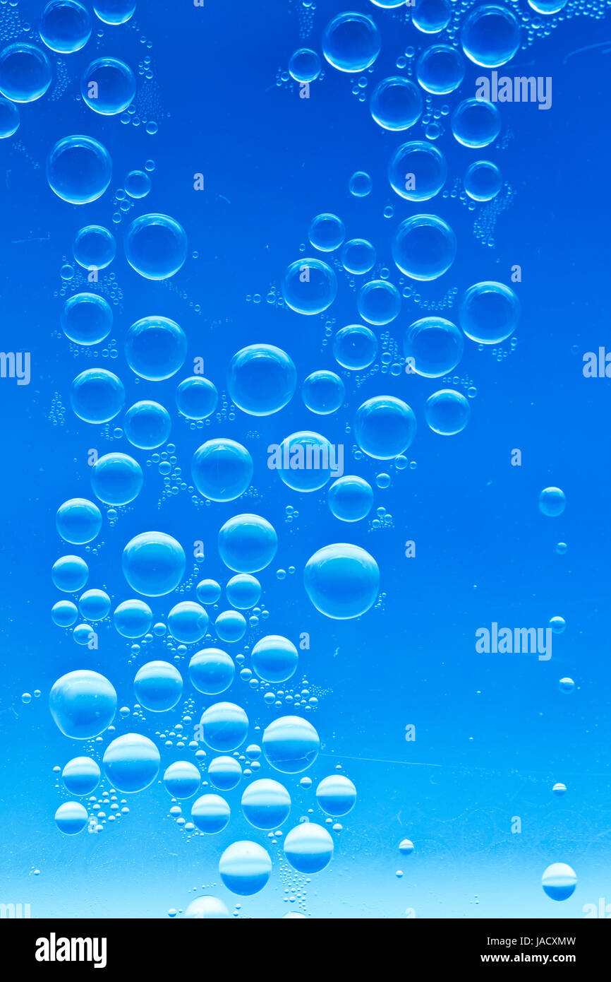 Drops of water on a bright blue background Stock Photo - Alamy