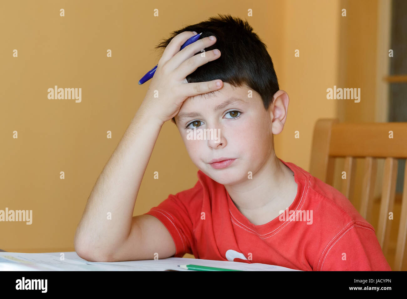 boy doing school homework, is tired and bored Stock Photo - Alamy