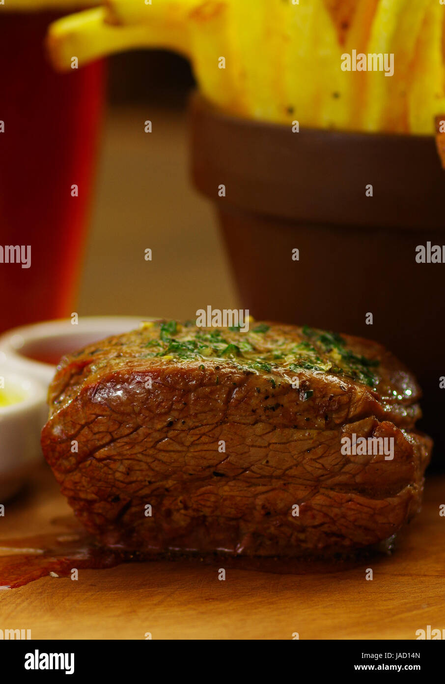 Welldone grilled marinated beef flank steak with french fries on