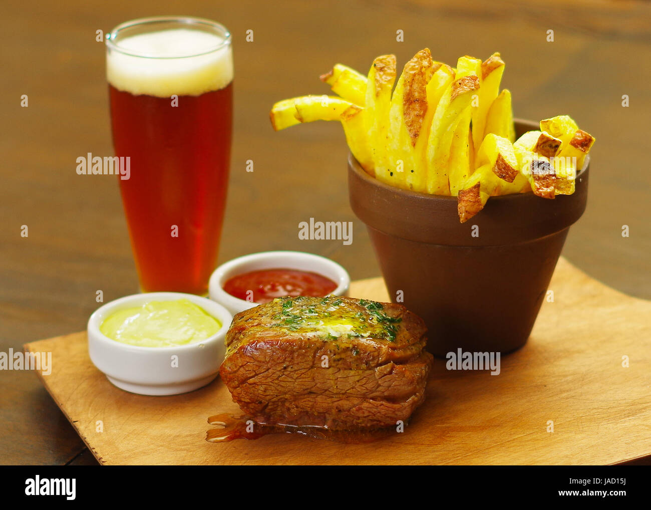 Welldone grilled marinated beef flank steak with ketchup, mustard and